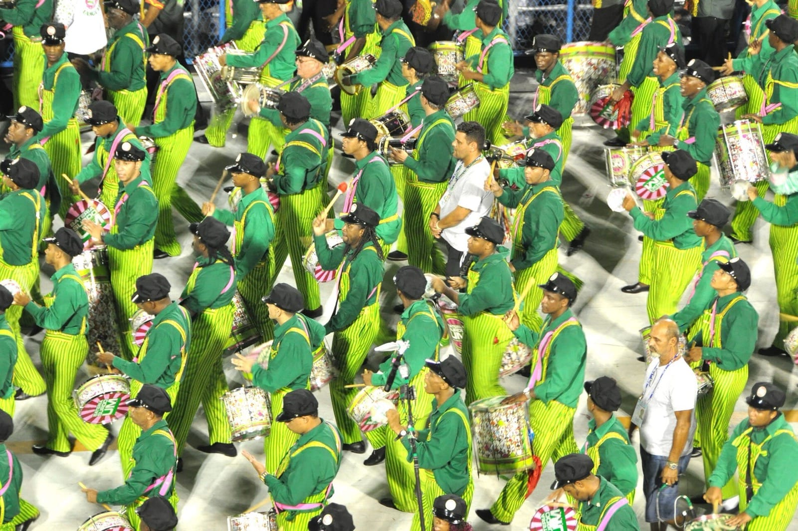 The drummers of a samba school parading in green and yellow through the Sambadrome in Rio