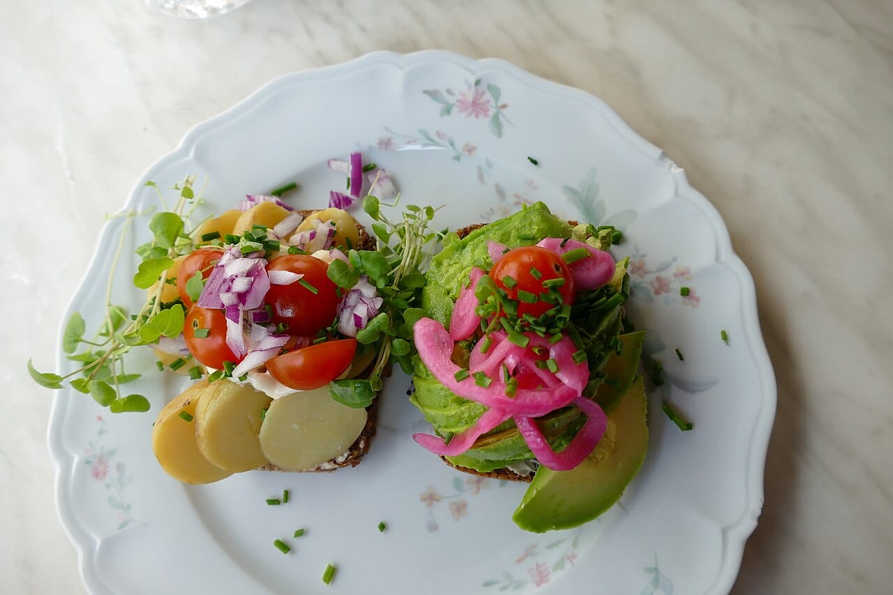 Two pieces of smørrebrød on rye, served in a Copenhagen cafe