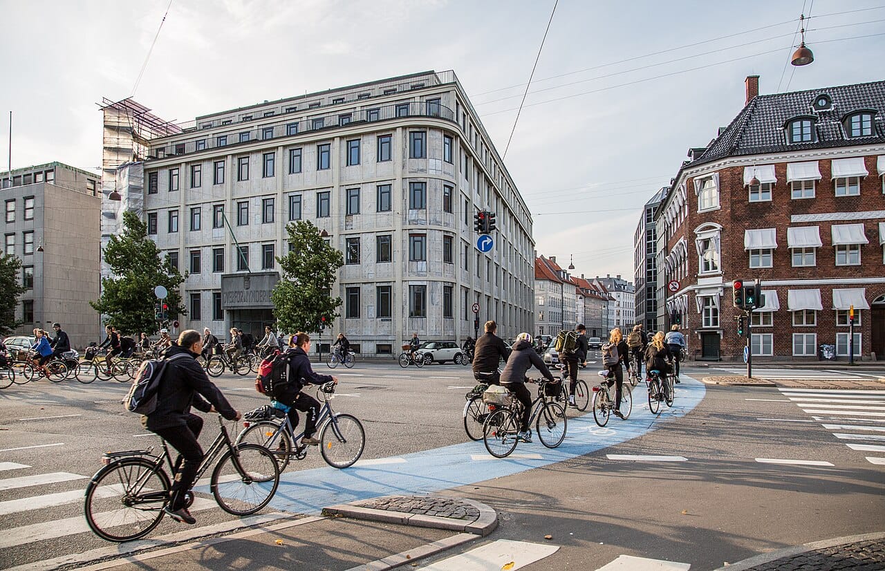 Cyclists crossing Holmens Kanal in Copenhagen on the blue-painted bike lane