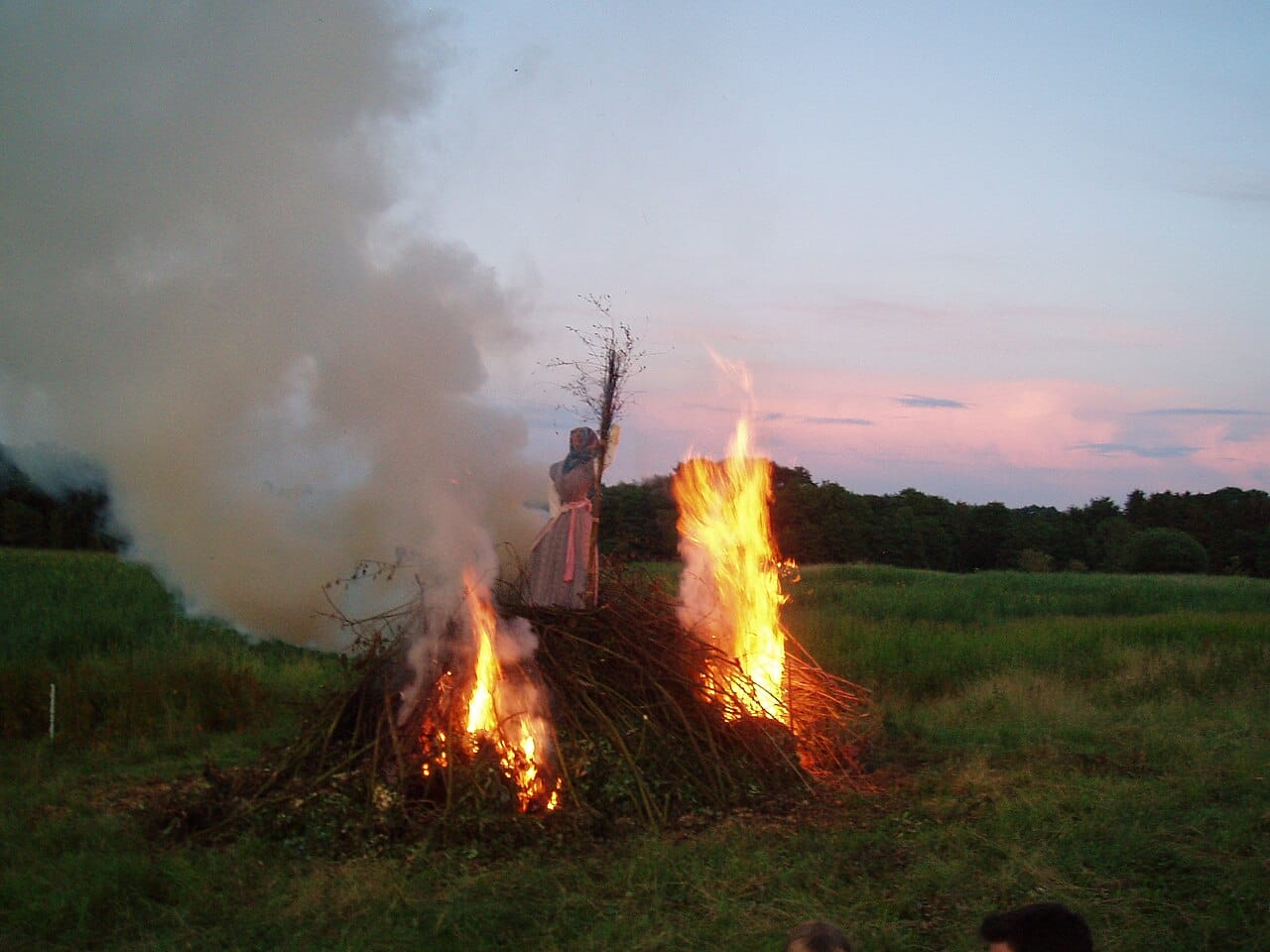 A Sankt Hans bonfire burning at dusk on Midsummer Eve