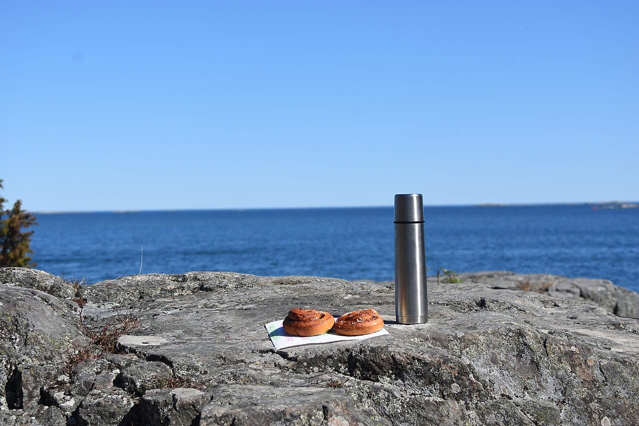 Cinnamon buns and coffee set out for fika on the Swedish coast