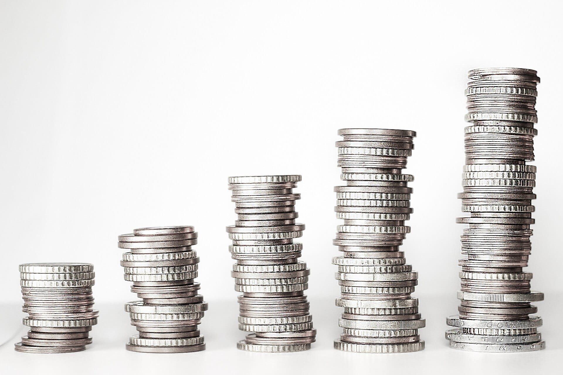 Five stacks of coins standing in a rising row