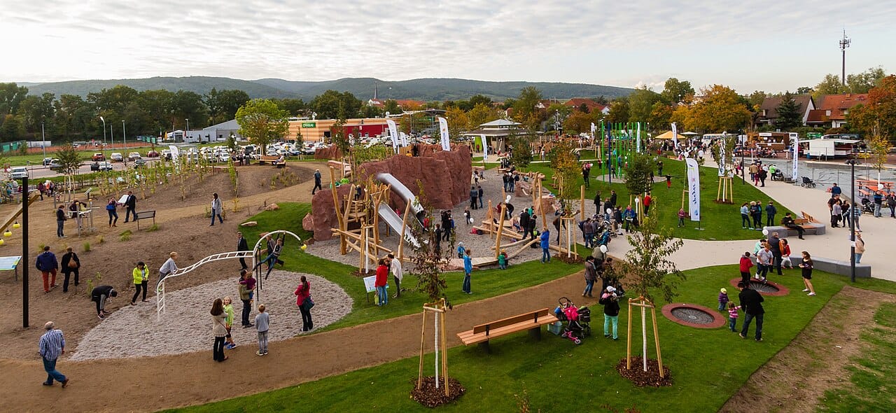 A wooden climbing frame in a public playground