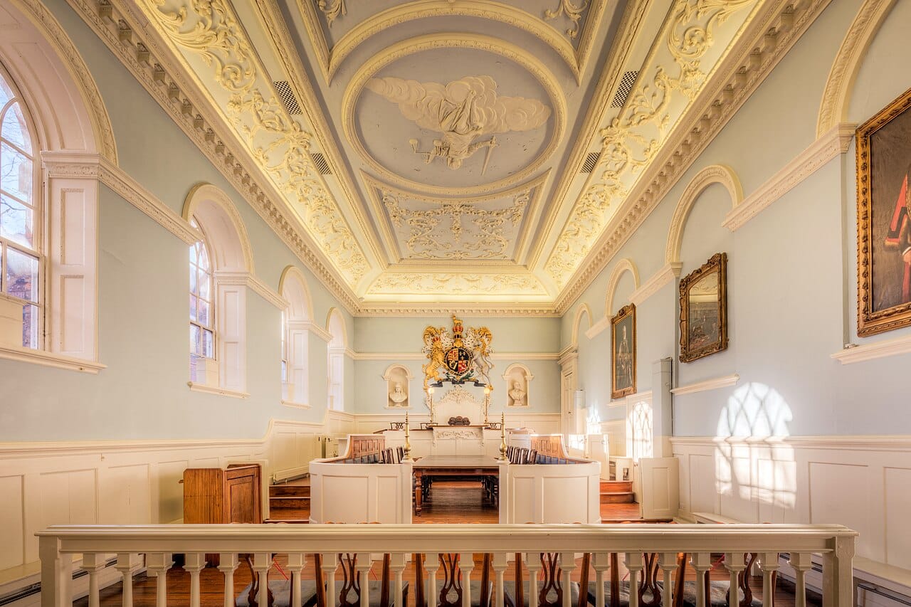 A panelled courtroom with the bench raised above the floor