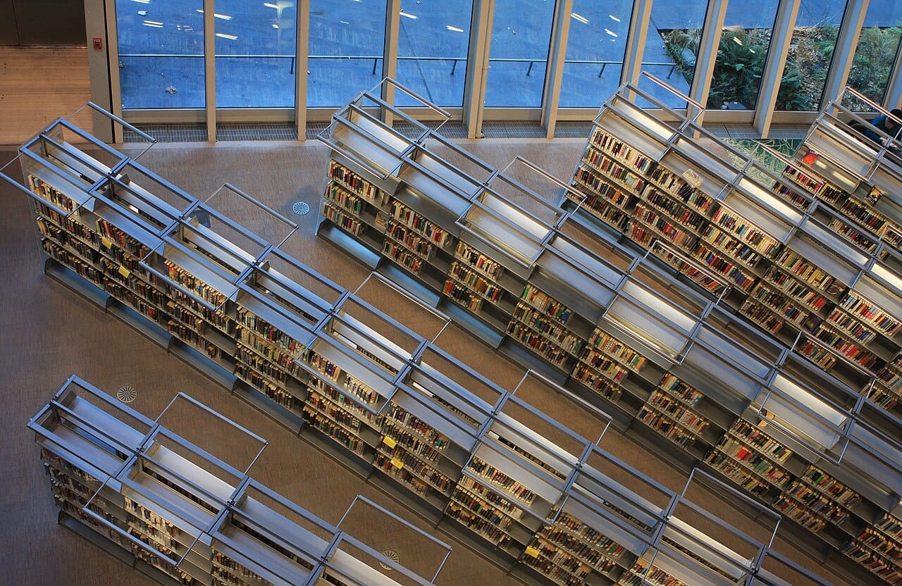 Rows of library shelving seen from above, the spines packed end to end