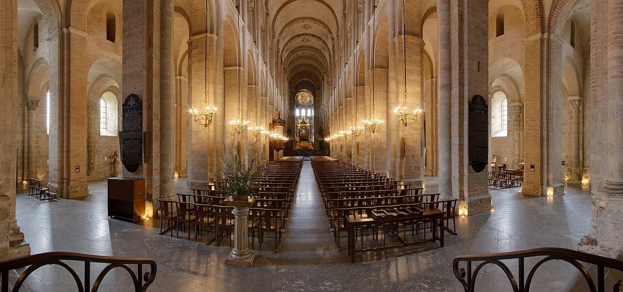 The long nave of a church, arches receding towards the altar