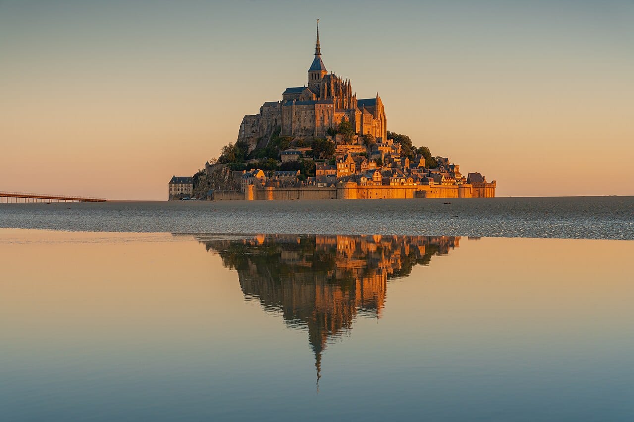 Mont-Saint-Michel glowing at sunrise off the Normandy coast