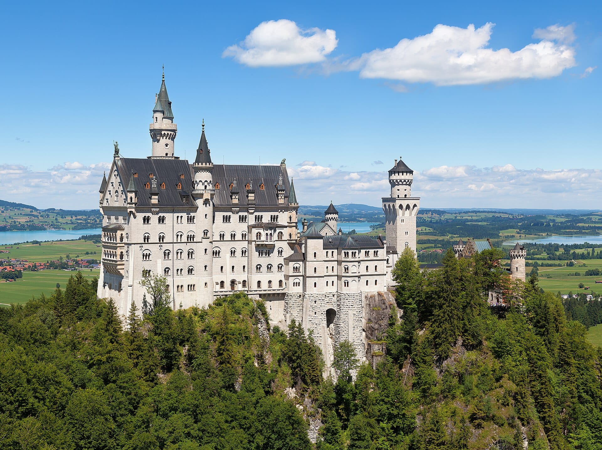 Neuschwanstein Castle above the forested Bavarian foothills