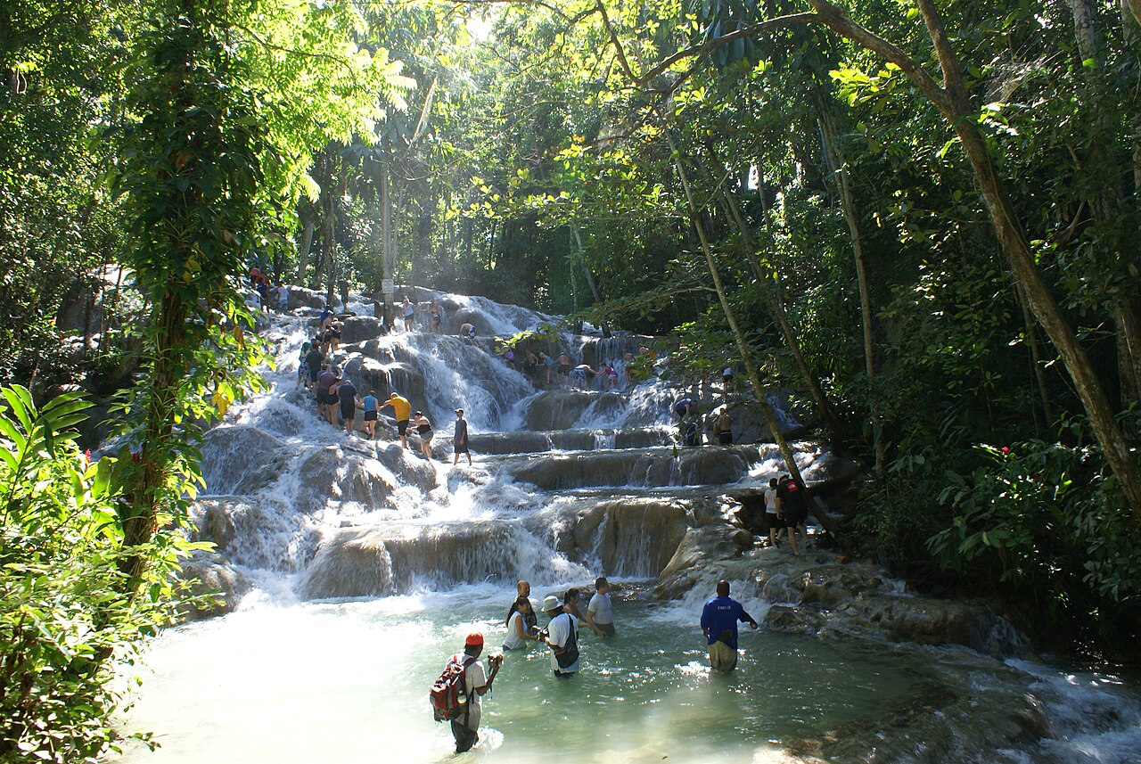Visitors following a guide up Dunnโs River Falls near Ocho Rios