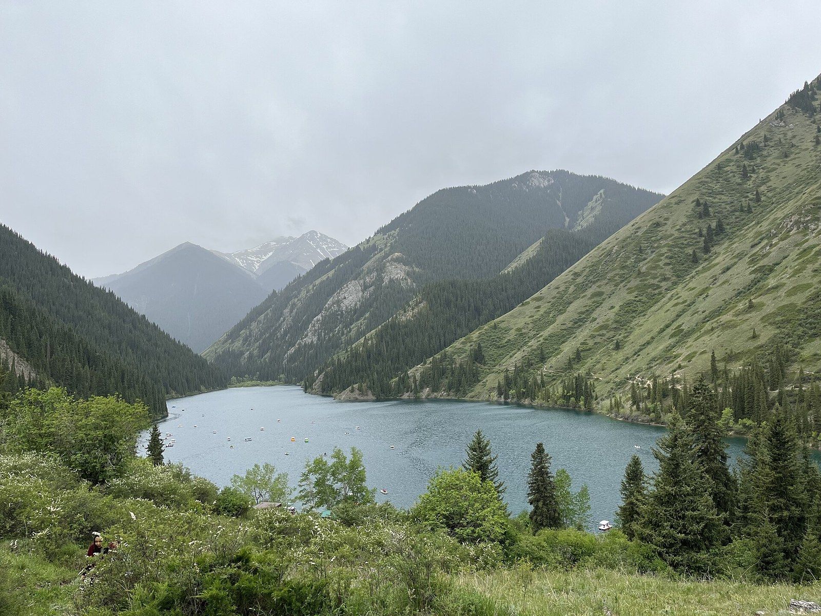 The lower Kolsai lake surrounded by spruce forests and Tian Shan mountains