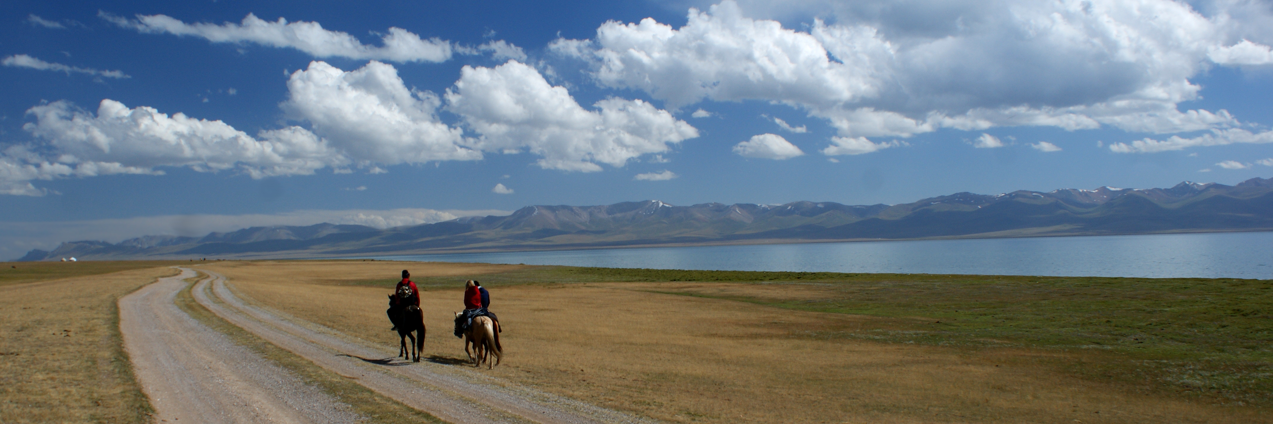 Horse riders beside Song-Kol in the Kyrgyz highlands