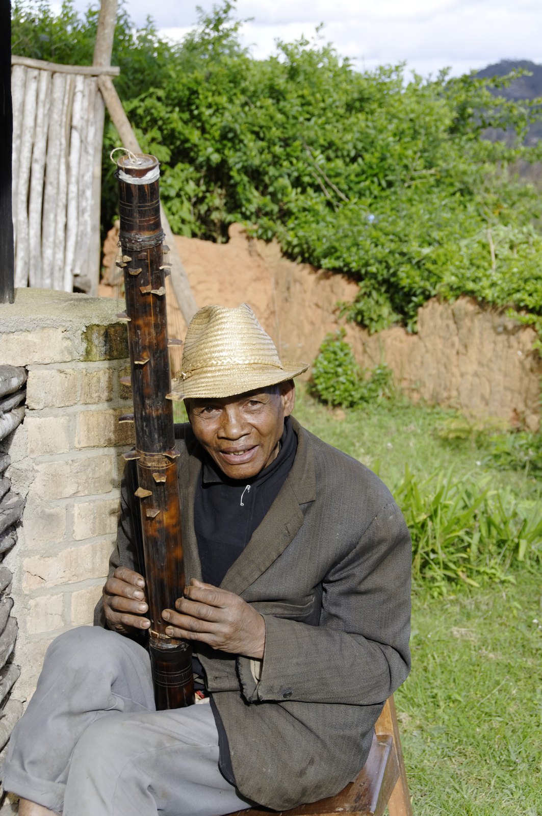 A musician playing a bamboo valiha in Ambohimahasoa