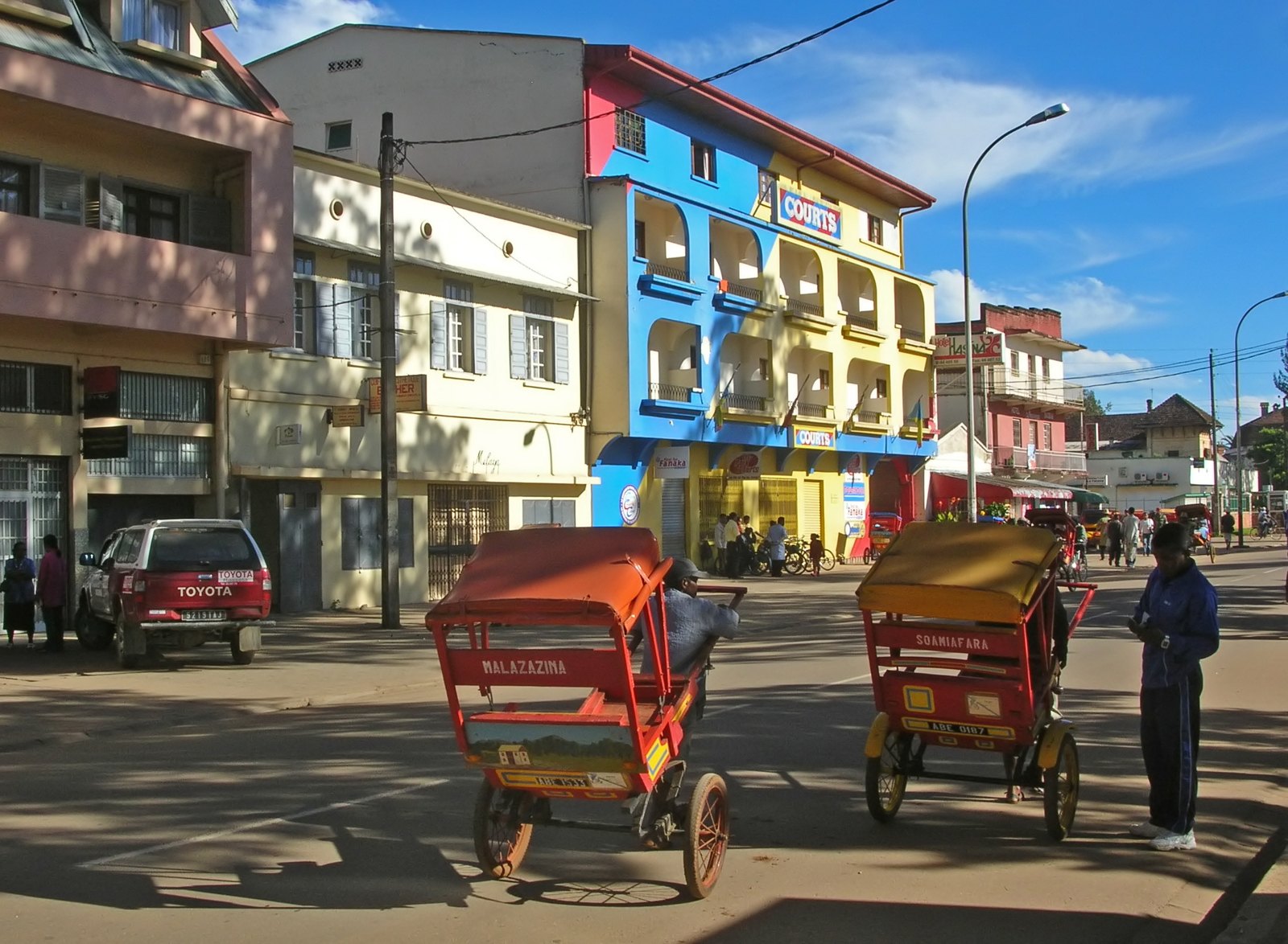 Rickshaws and buildings along a street in Antsirabe