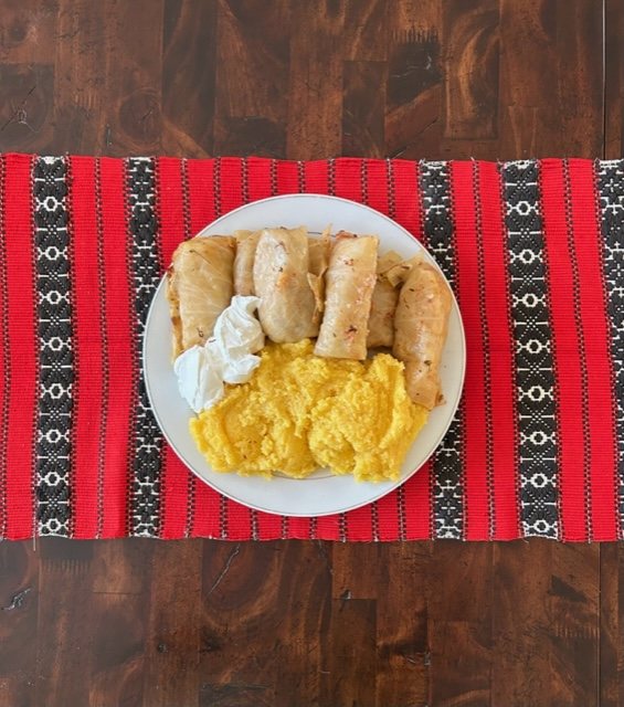Sarmale served with polenta and sour cream