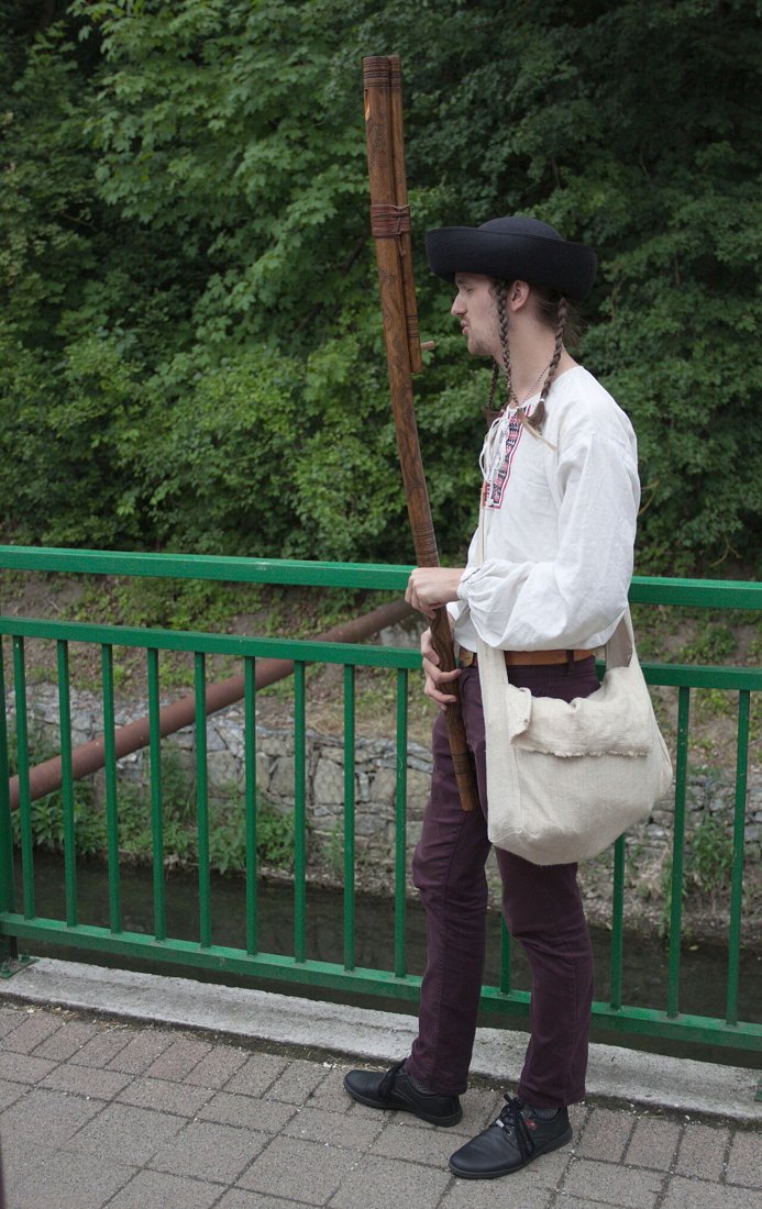 Jano Adamek playing a long wooden fujara at the Myjava festival
