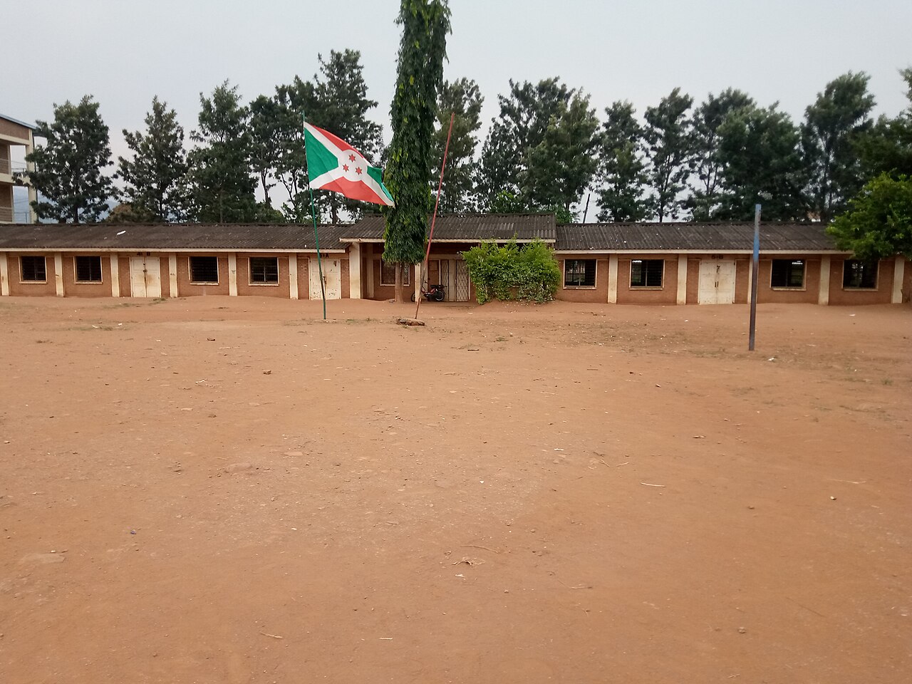 School buildings and the Burundian flag in a school courtyard