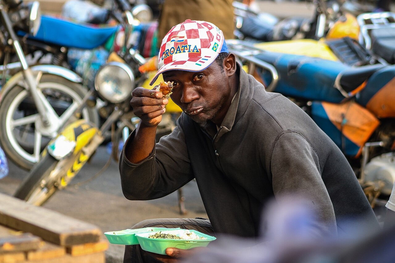 A man eating ndolé in Douala, Cameroon