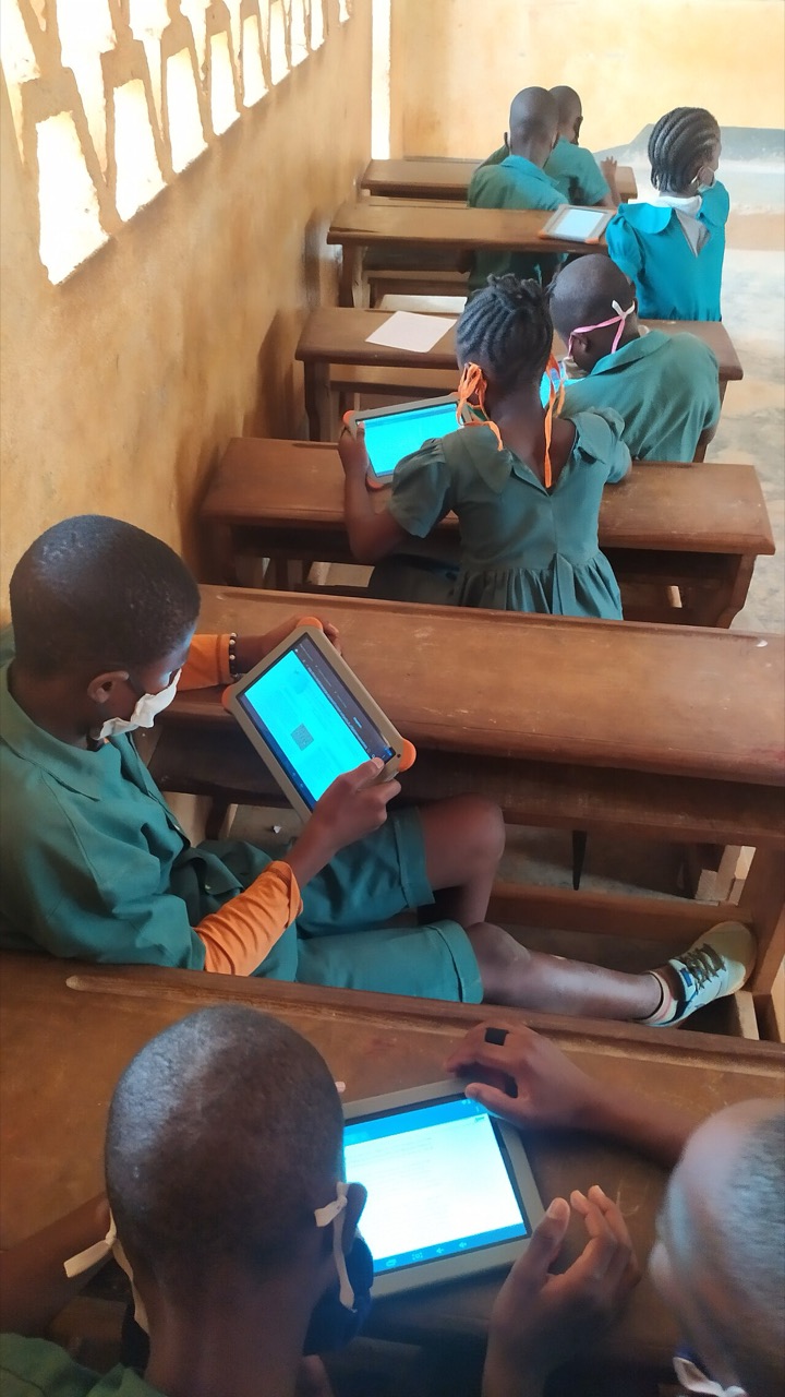 Pupils learning to use tablets at a school, Cameroon