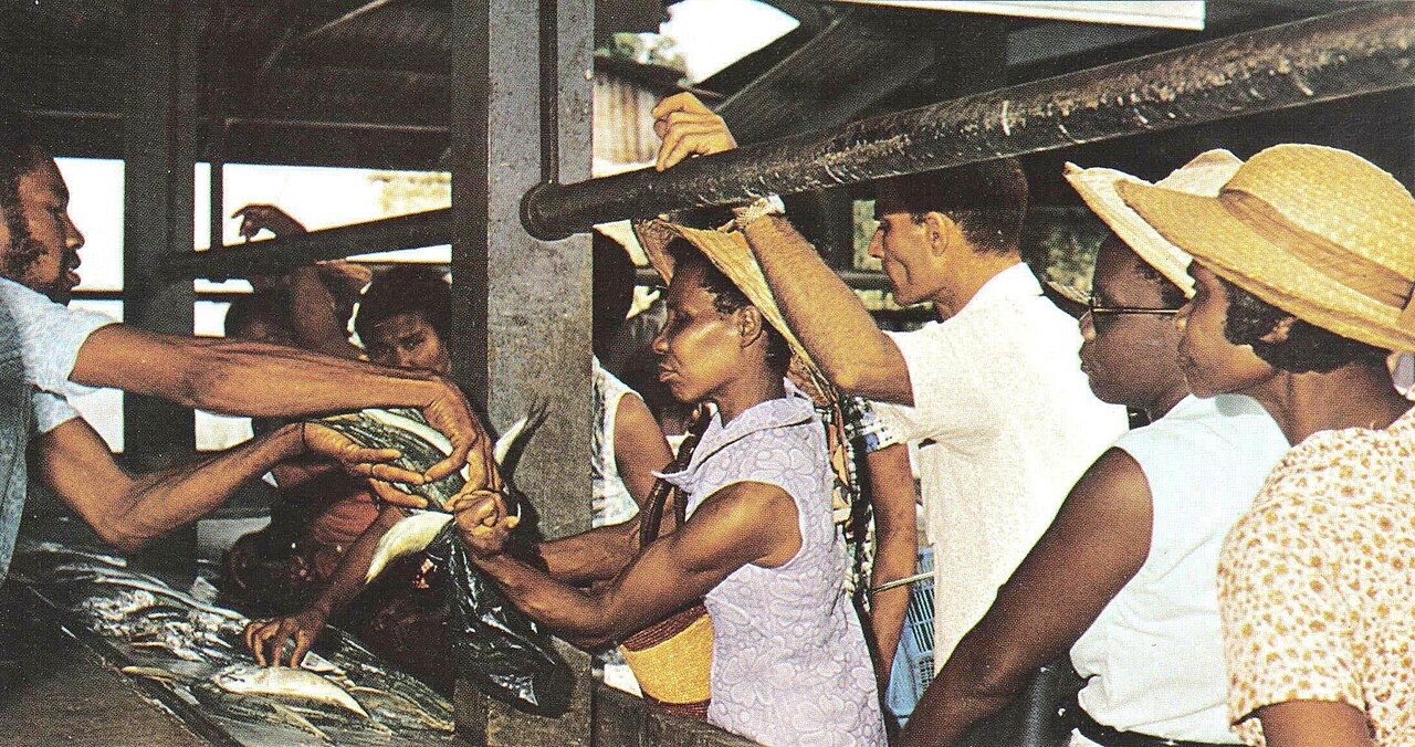 People buying fish at a market, Seychelles
