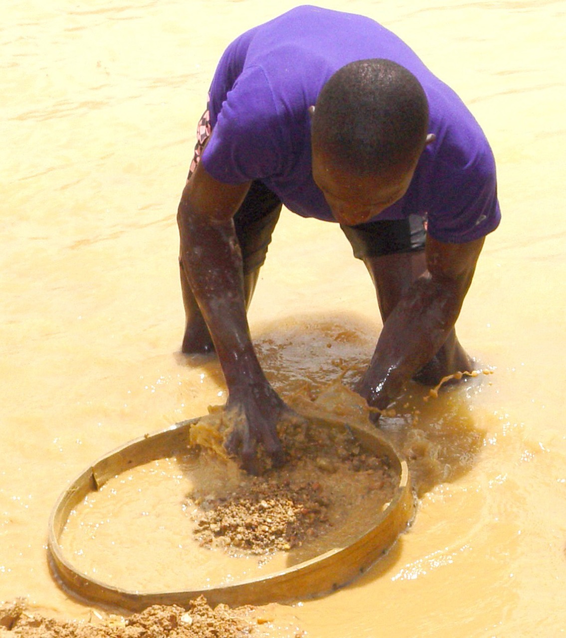 An alluvial diamond miner in Kono District, Sierra Leone