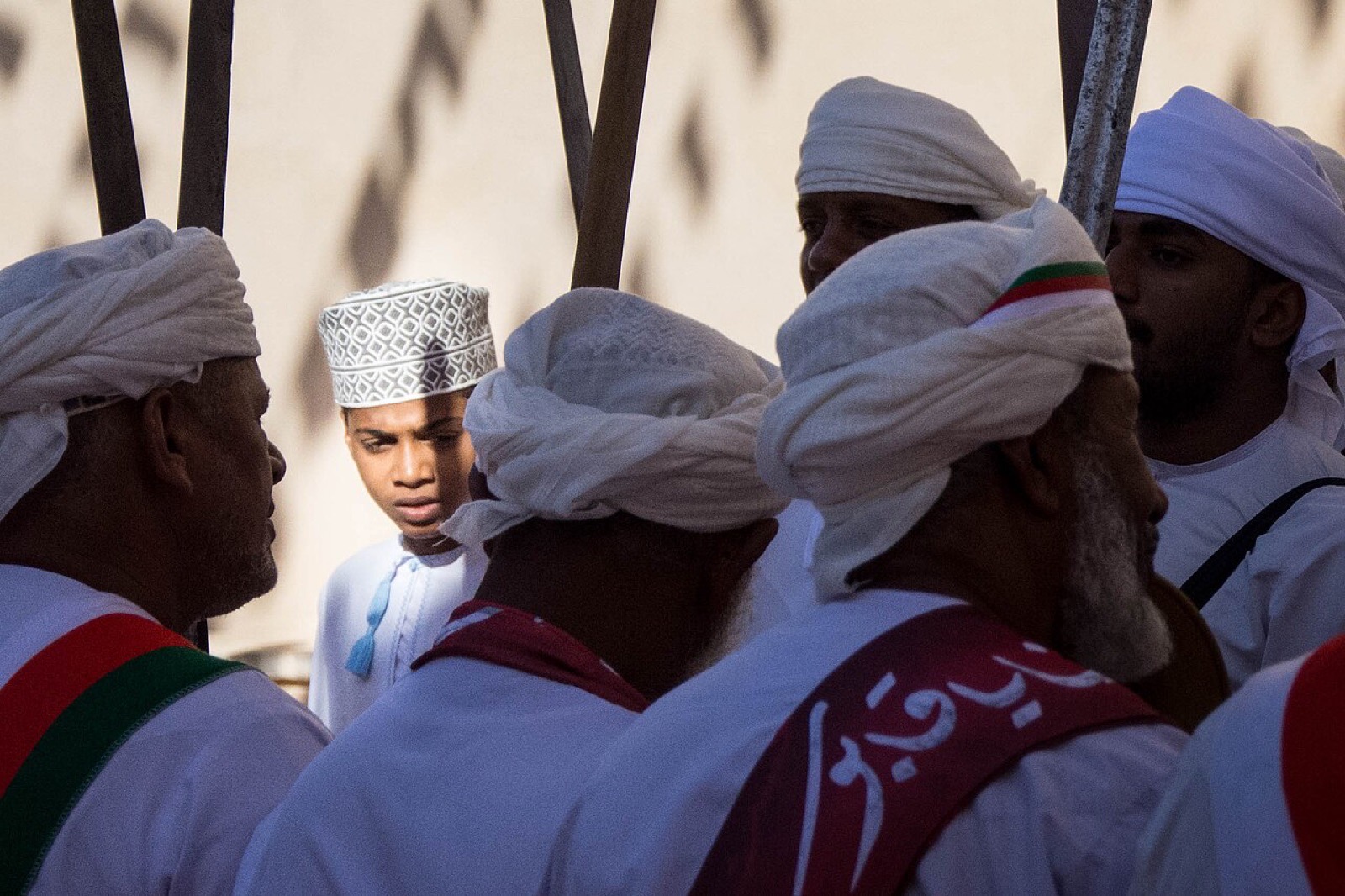 Men dancing and singing at a National Day celebration in Nizwa, Oman