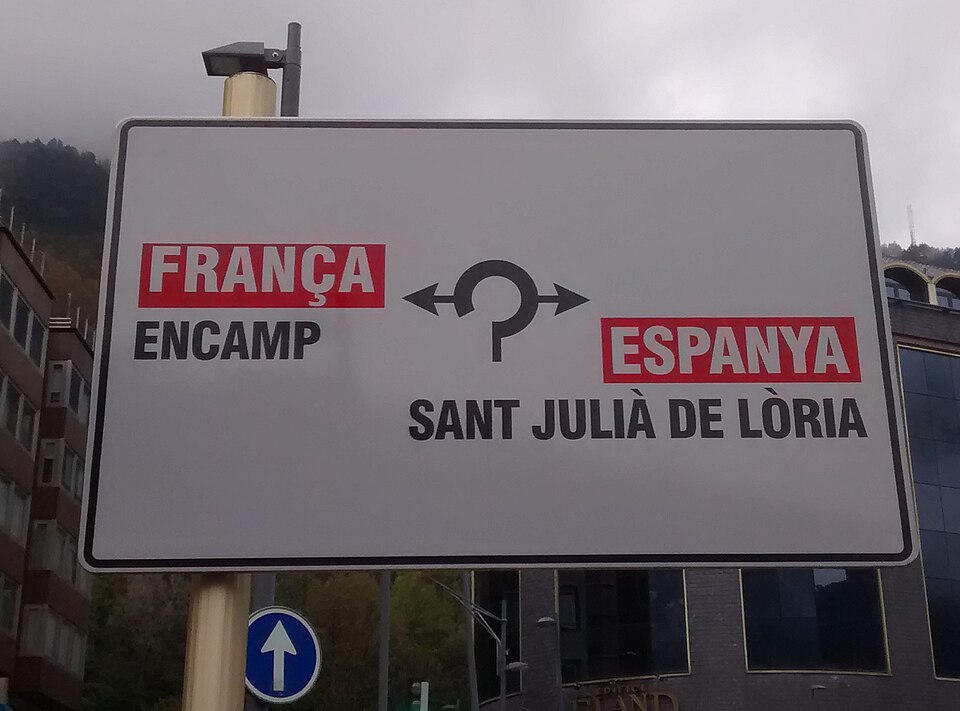 A road sign in Andorra pointing to Encamp, France and Sant Julià de Lòria