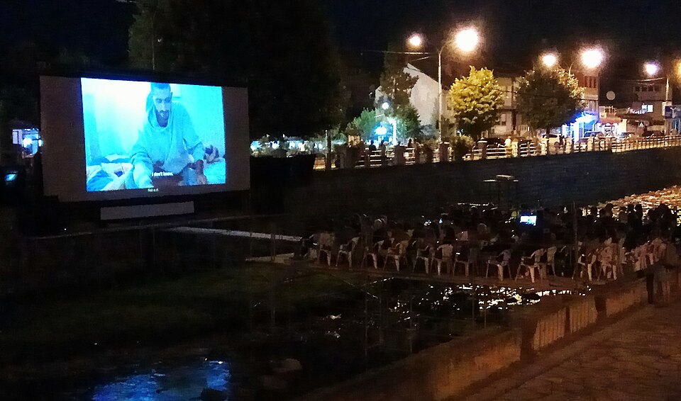 An outdoor riverside cinema at DokuFest in Prizren