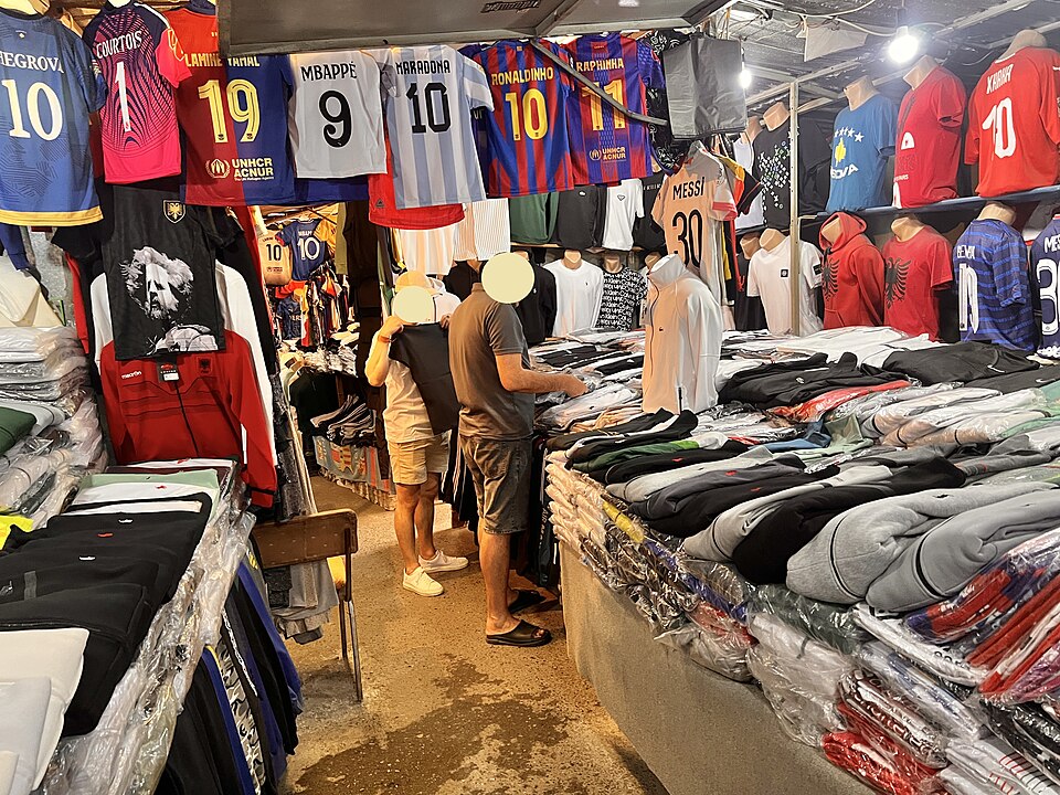 A customer and seller among clothing stalls at Pristina’s Green Market