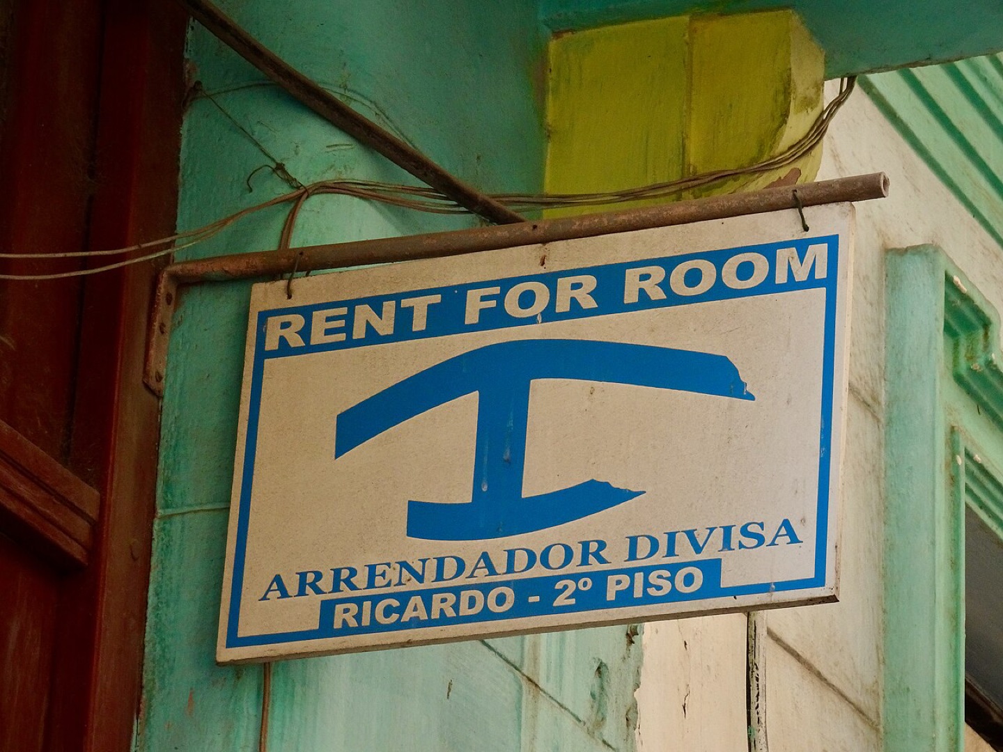 English and Spanish lettering on a room rental sign in Havana, Cuba