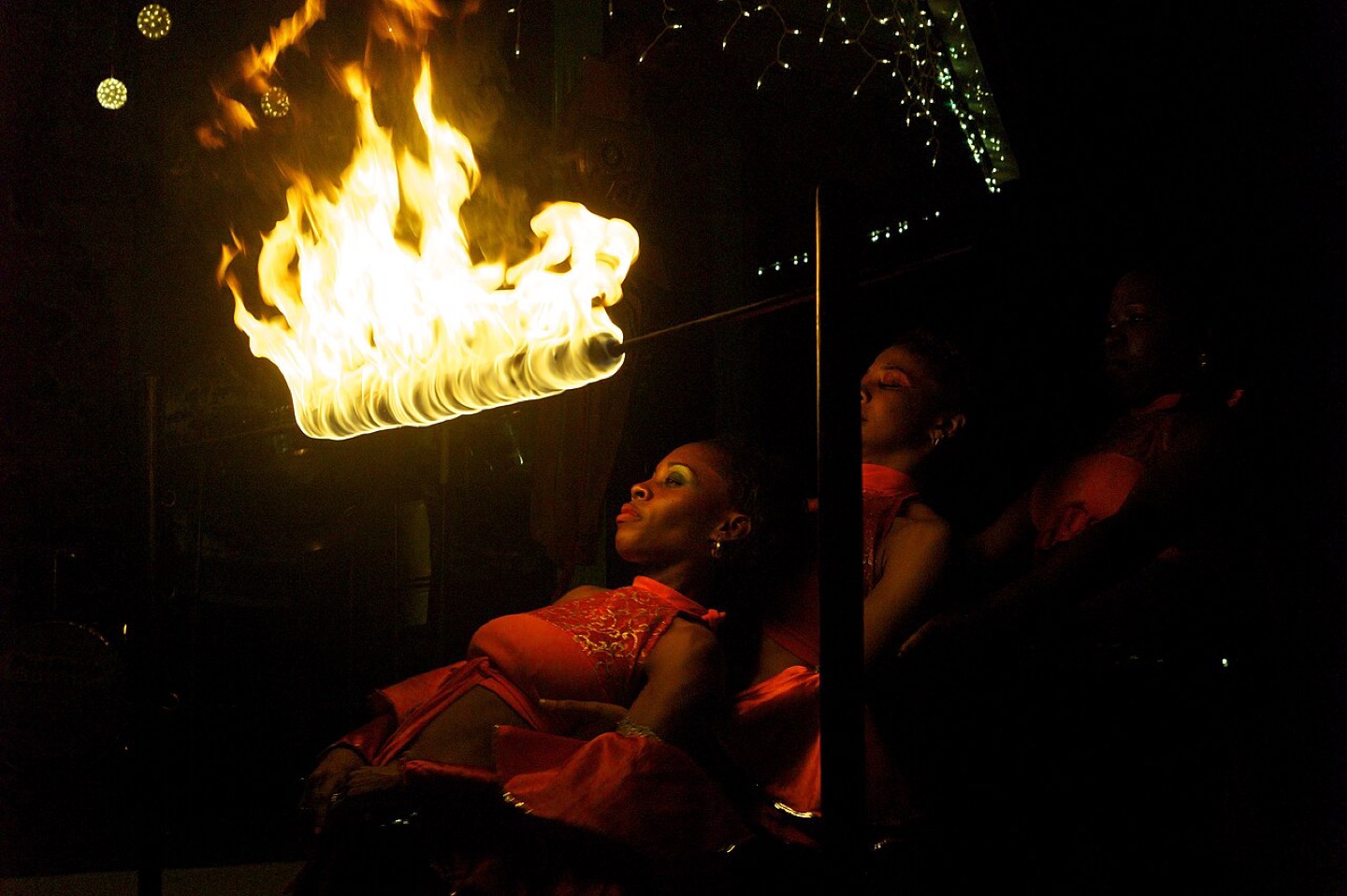Fire dancers with a limbo pole in Saint Lucia