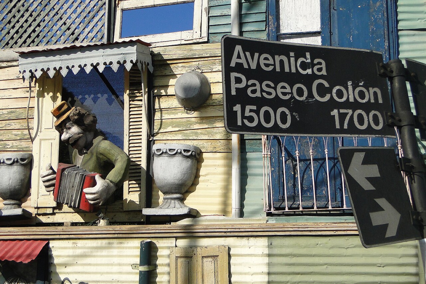 A street sign and decorated facade in La Boca, Buenos Aires