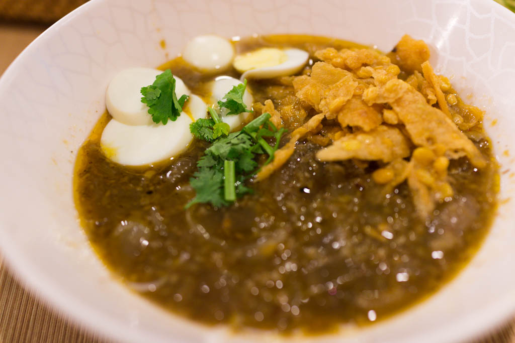 A bowl of mohinga with rice noodles and fish broth