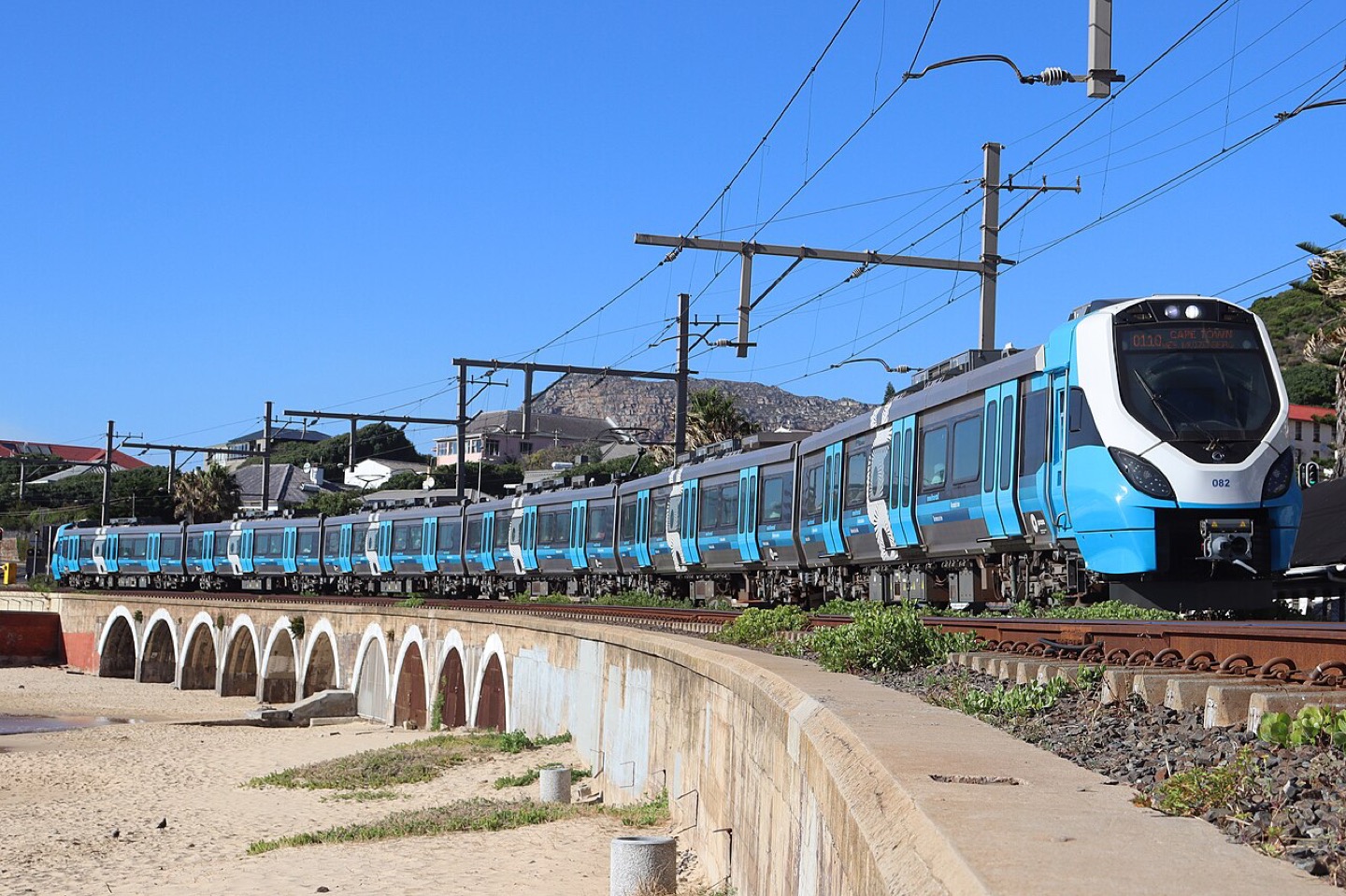 A passenger train crossing the bridge at Kalk Bay, South Africa