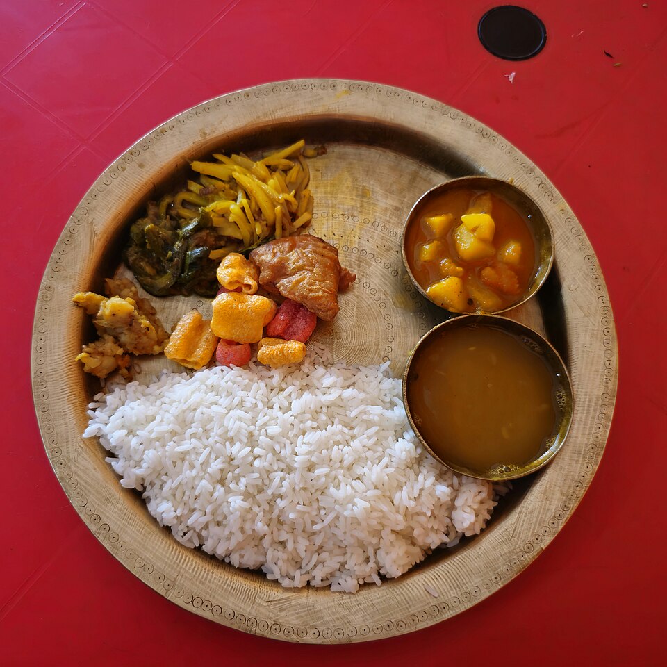 An Assamese thali with rice and small dishes