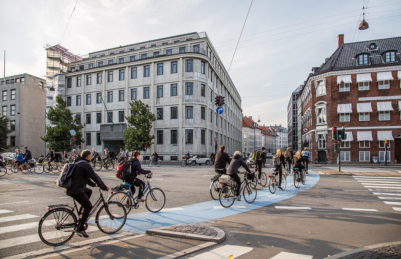 Cyclists crossing Holmens Kanal in Copenhagen on the blue-painted bike lane