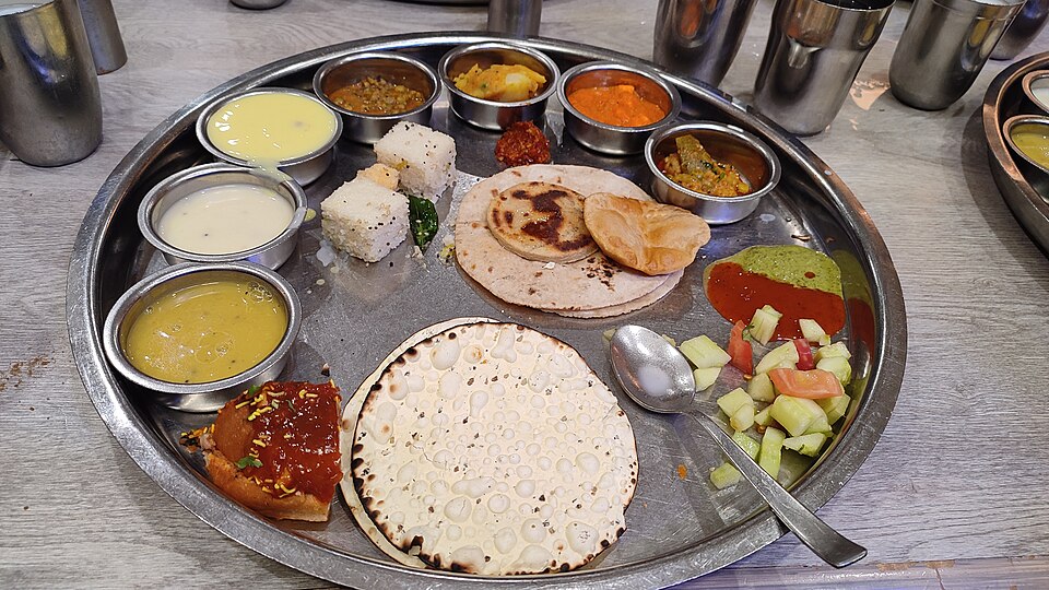 A Gujarati thali with a variety of small dishes