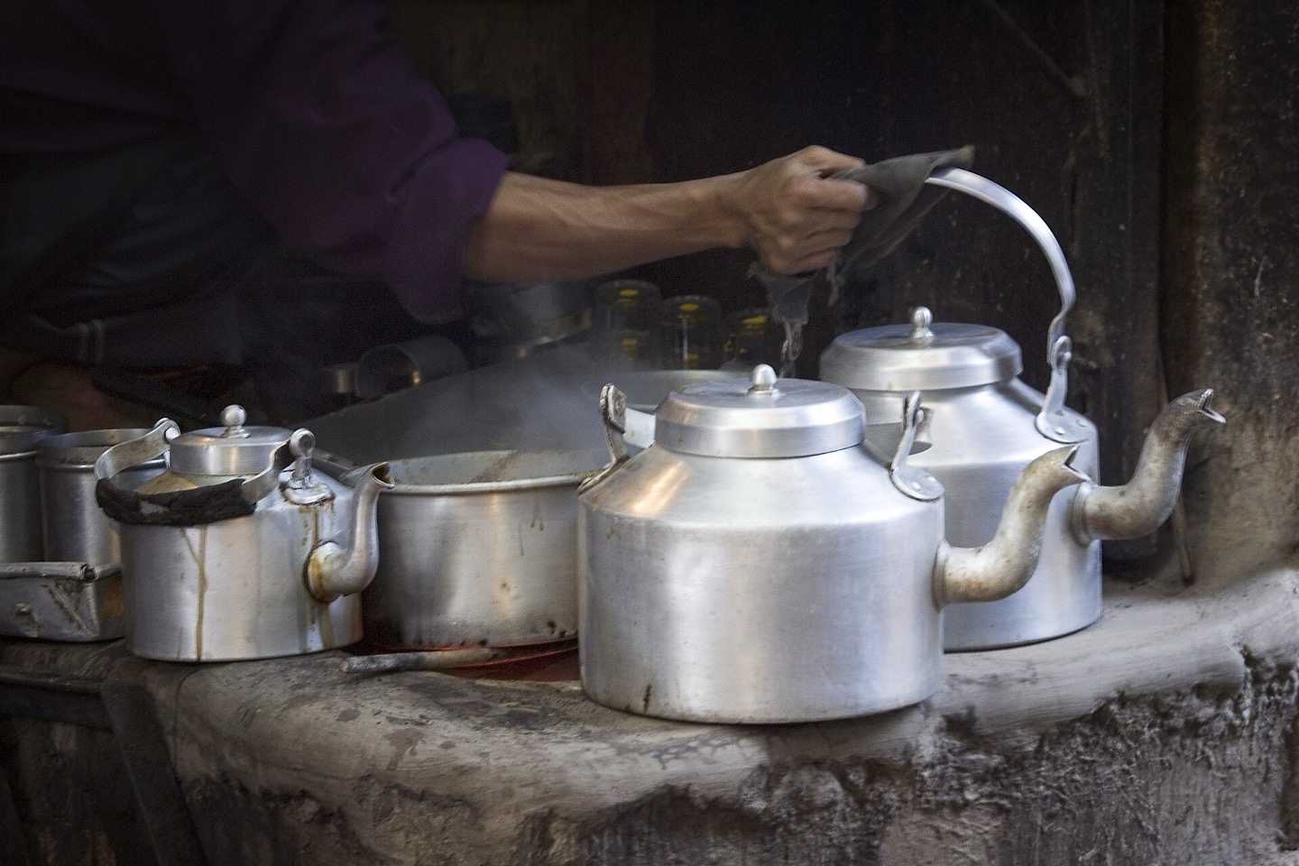Glasses of chai being poured at a tea stall in Varanasi