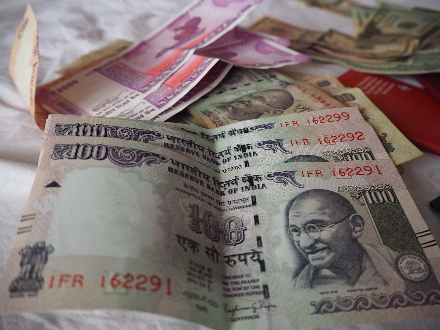 Indian hundred and two thousand rupee notes fanned out