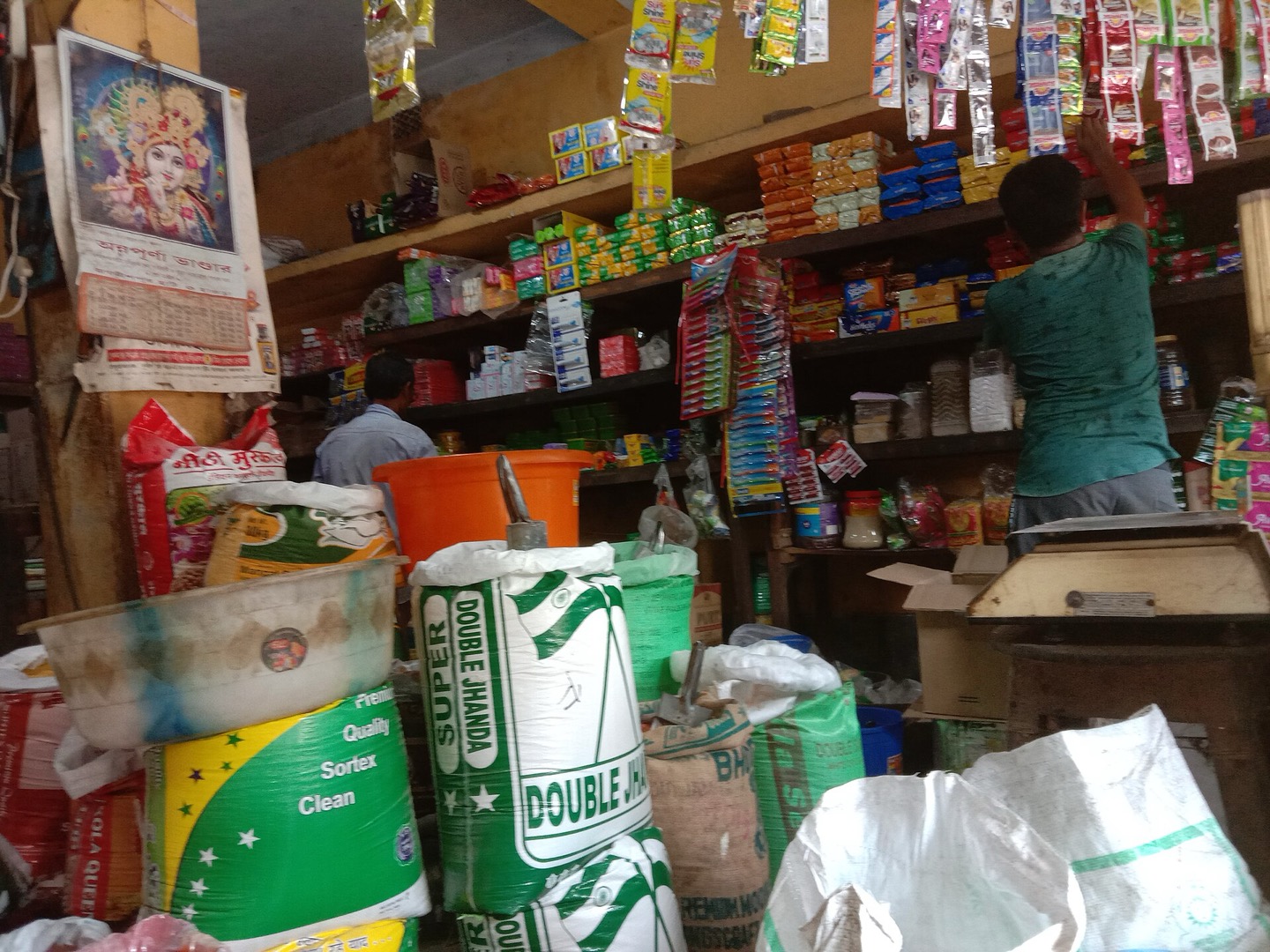 The shelves and sacks inside a neighbourhood grocery shop in West Bengal