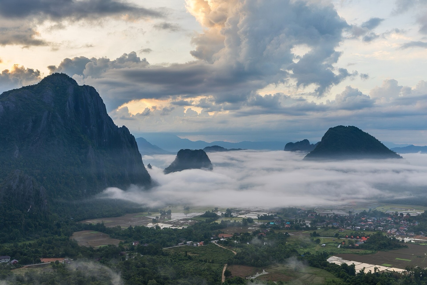 Karst peaks above the clouds at sunrise in Vang Vieng, Laos