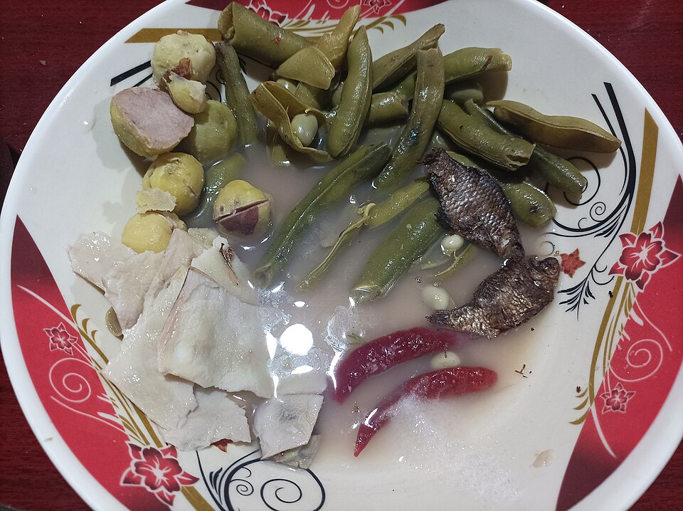 A plate of boiled vegetables, fish and chili, the makings of eromba