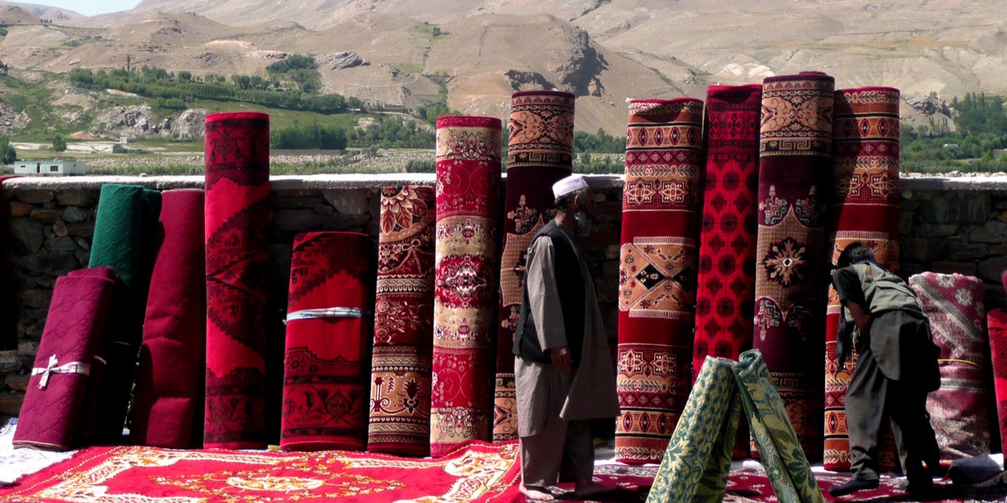Afghan carpets displayed against the Pamir Mountains