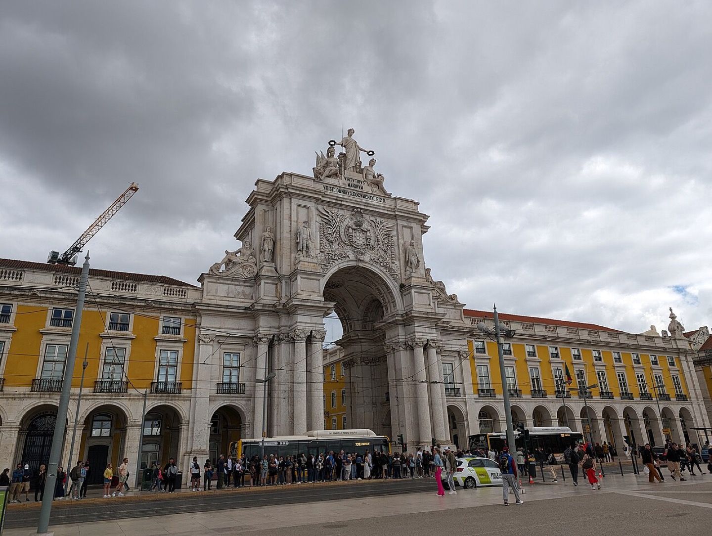 People walking under the Rua Augusta arch in the Baixa of Lisbon
