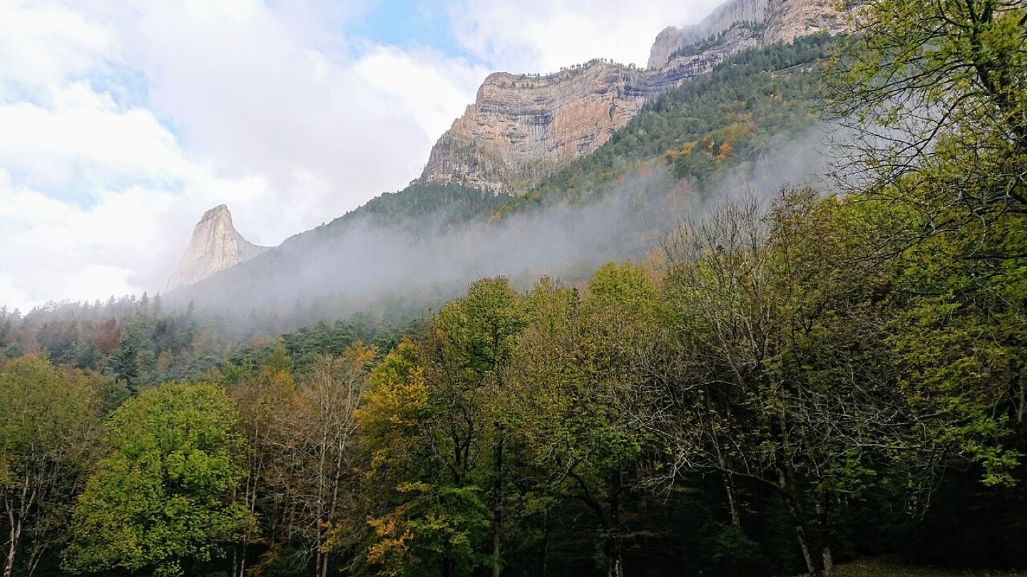 Cloud breaking over the limestone walls of the Ordesa valley in the Pyrenees