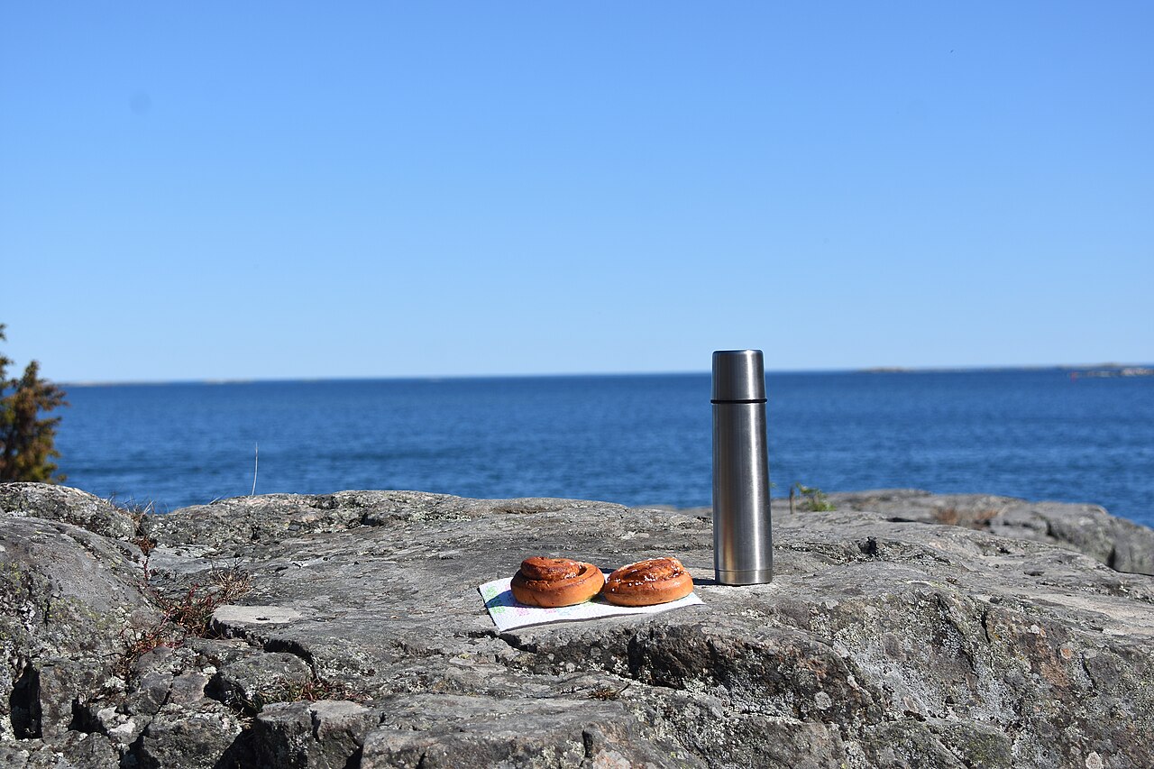 Cinnamon buns and coffee set out for fika on the Swedish coast
