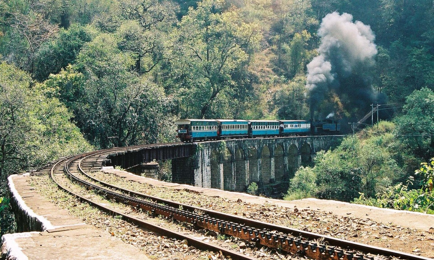 A Nilgiri Mountain Railway train on a viaduct in Tamil Nadu, India