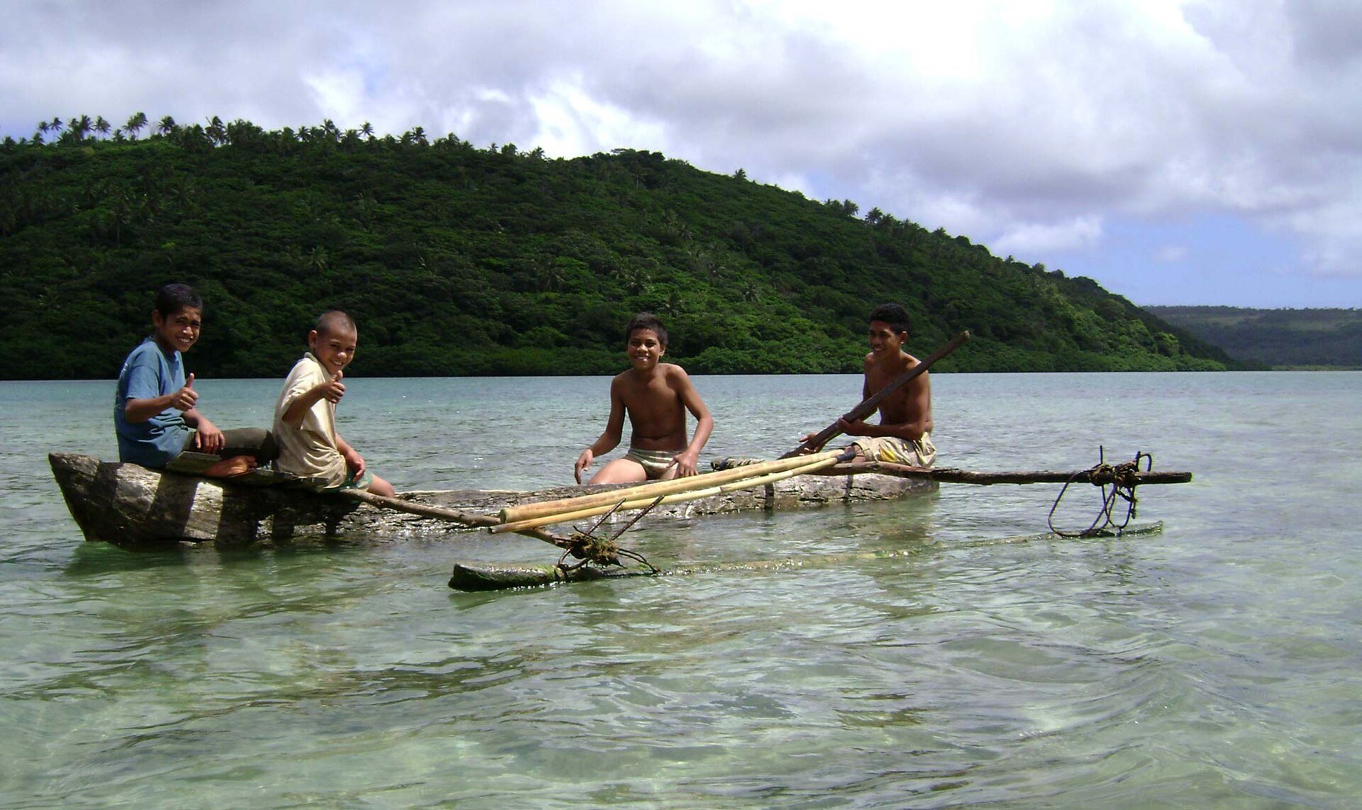 A traditional Tongan outrigger canoe on the water at Vavaʻu, Tonga