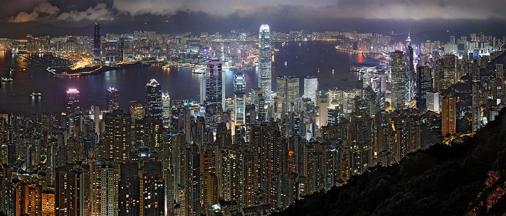 Victoria Harbour at night from the Peak, lit towers on both shores