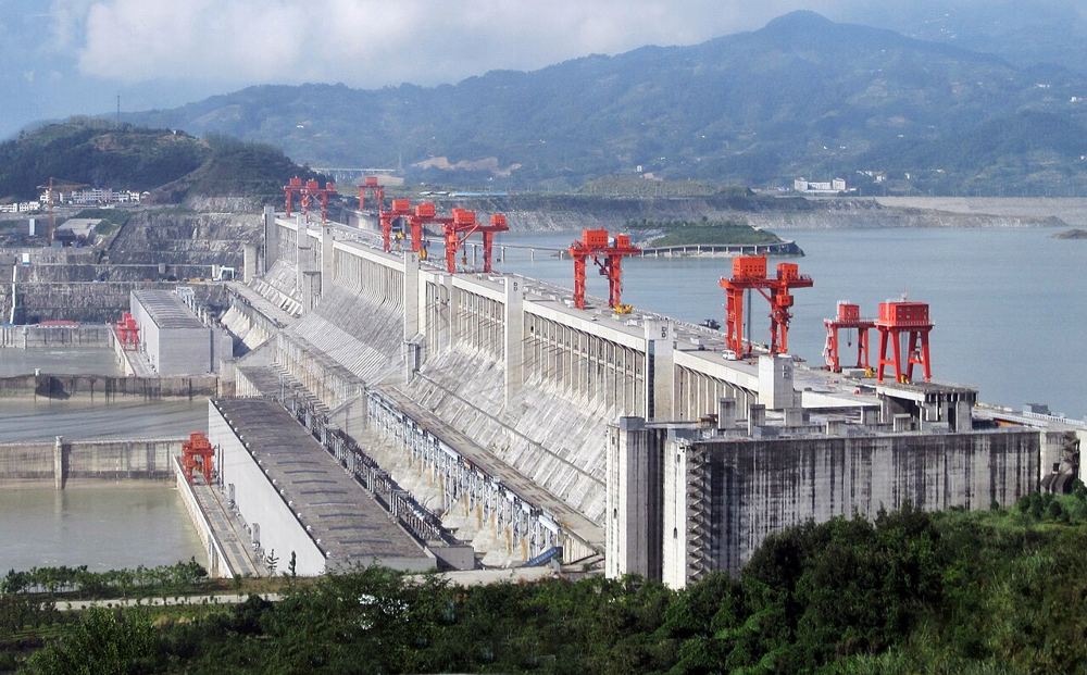 The Three Gorges Dam, its spillway gates under red cranes