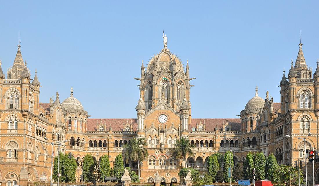 The stone domes and spires of Chhatrapati Shivaji Terminus against a blue sky
